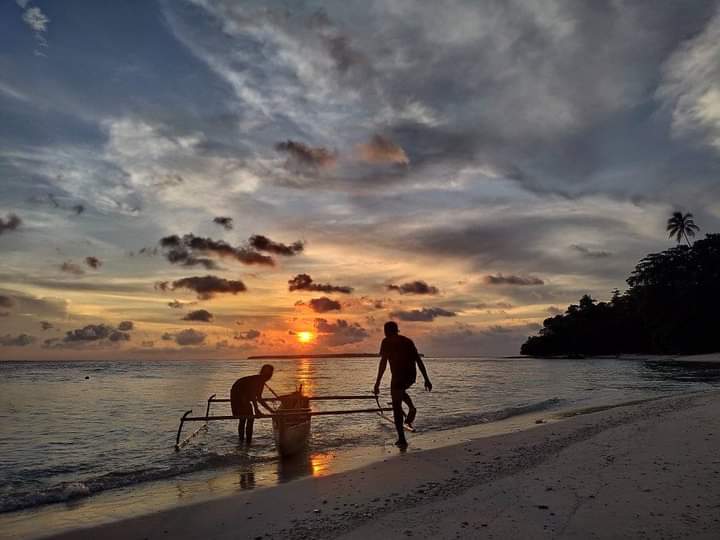 Nelayan Orang Asli Papua (OAP) dengan mengunakan Perahu tradisional dalam proses penangkapan Ikan mengunakan Jaring.